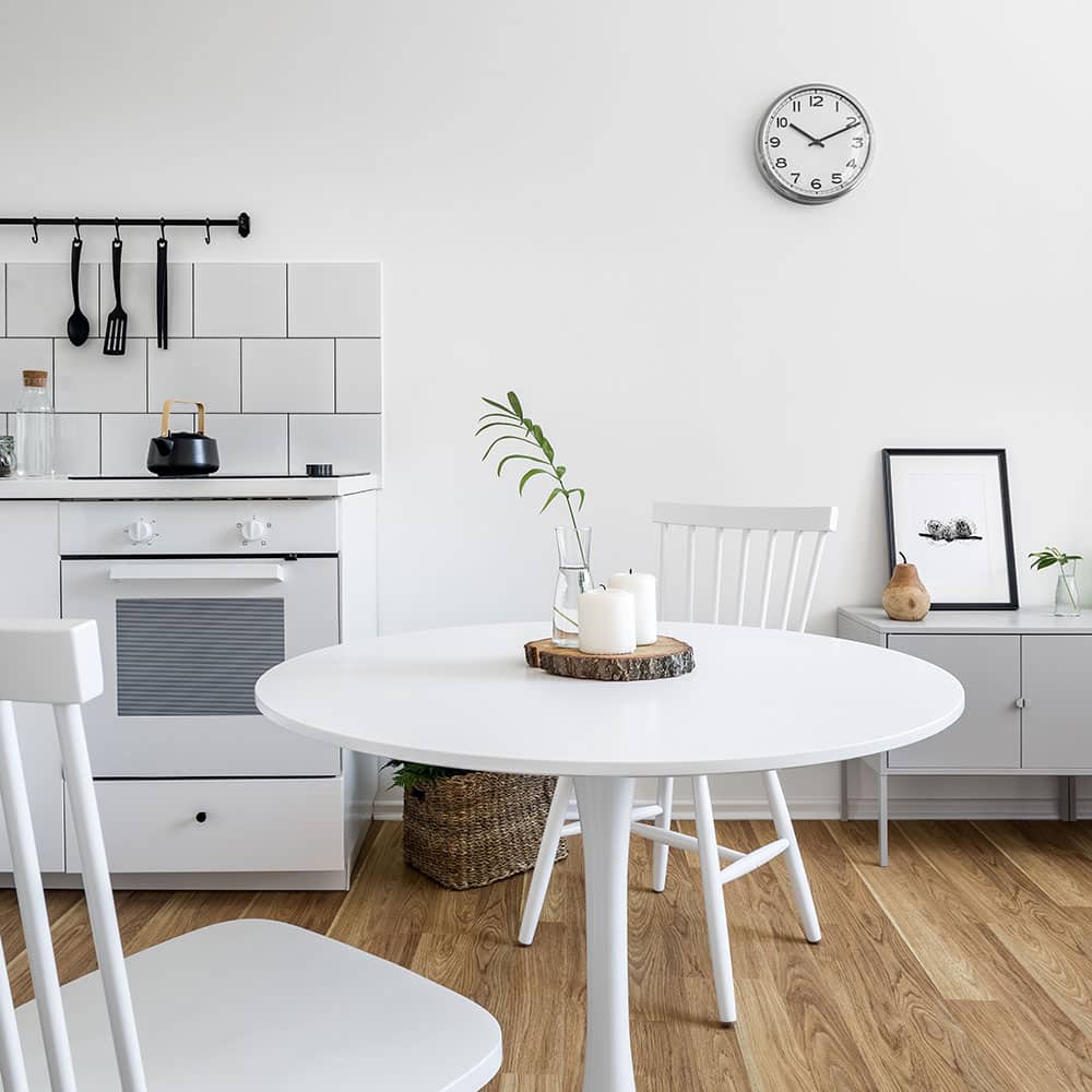 All white kitchen with white dining table and chairs